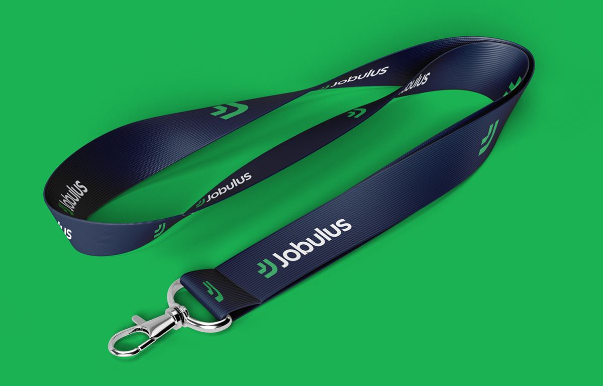 Navy Jobulus lanyard with repeating green logo on a bright green background